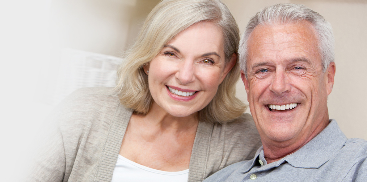 Older couple smiling together while exploring senior living options