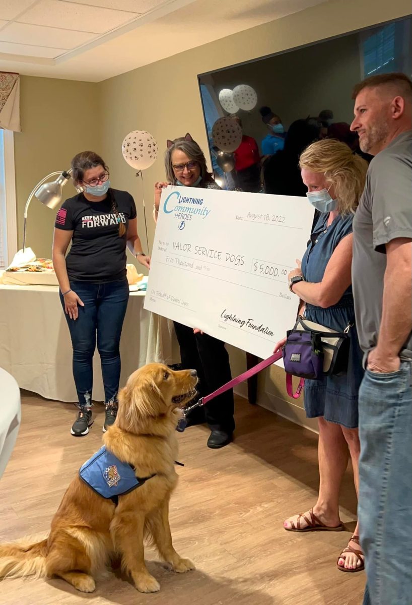 A large donation to Valor Service Dogs is presented at Twin Creeks Fundraising event