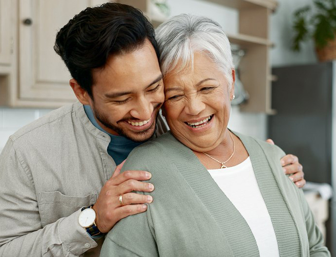 elderly Mom and son smiling together after coming to an agreement about a senior living community