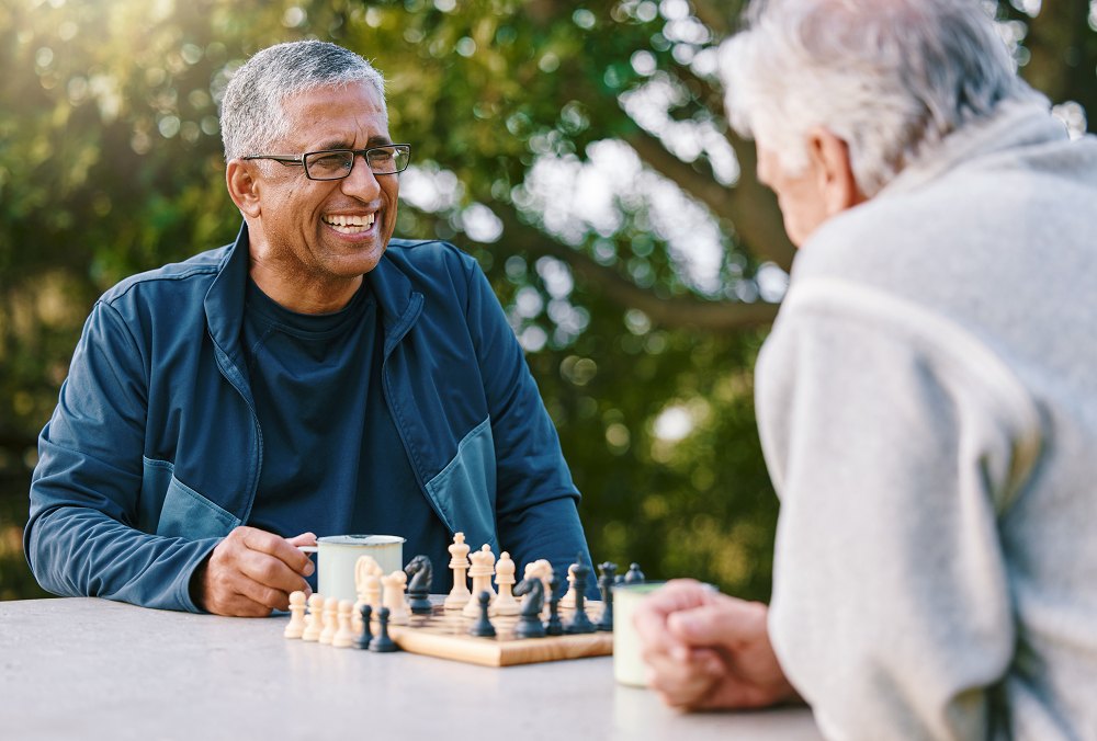 senior-men-friends playing chess outside