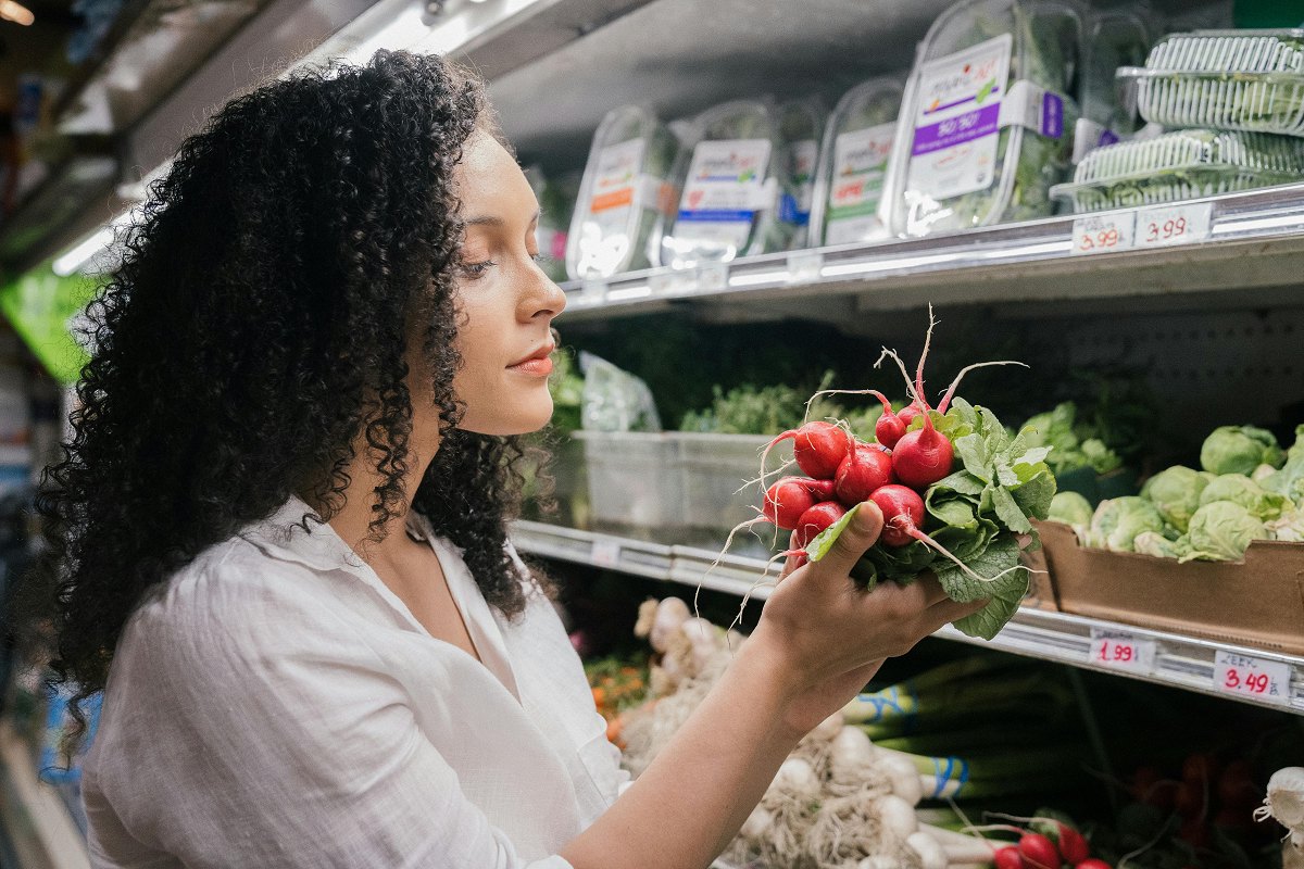 Woman making healthy choices at the grocery store to help her in supporting her dad with memory care challenges