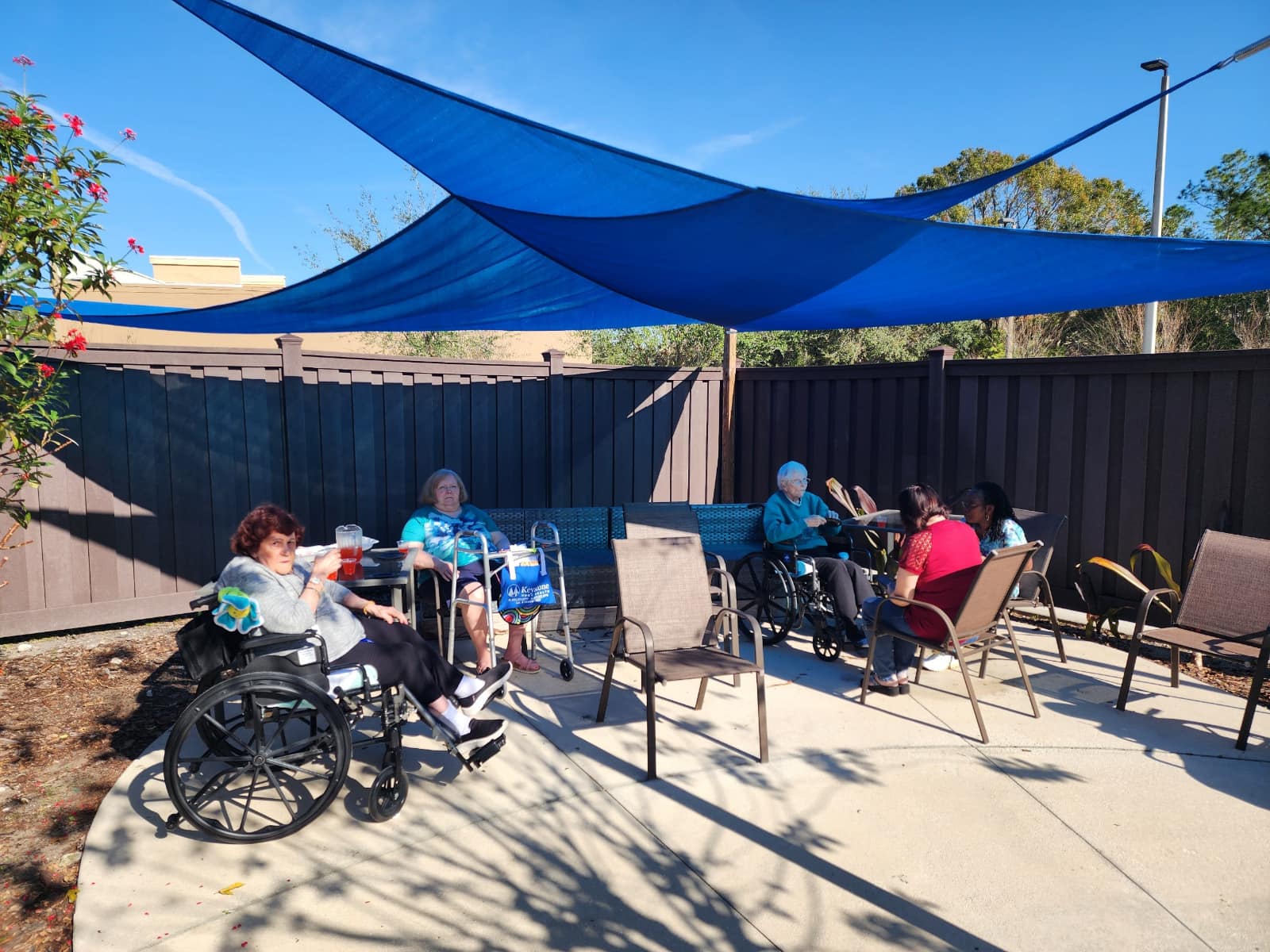 Residents enjoy the shade on the patio